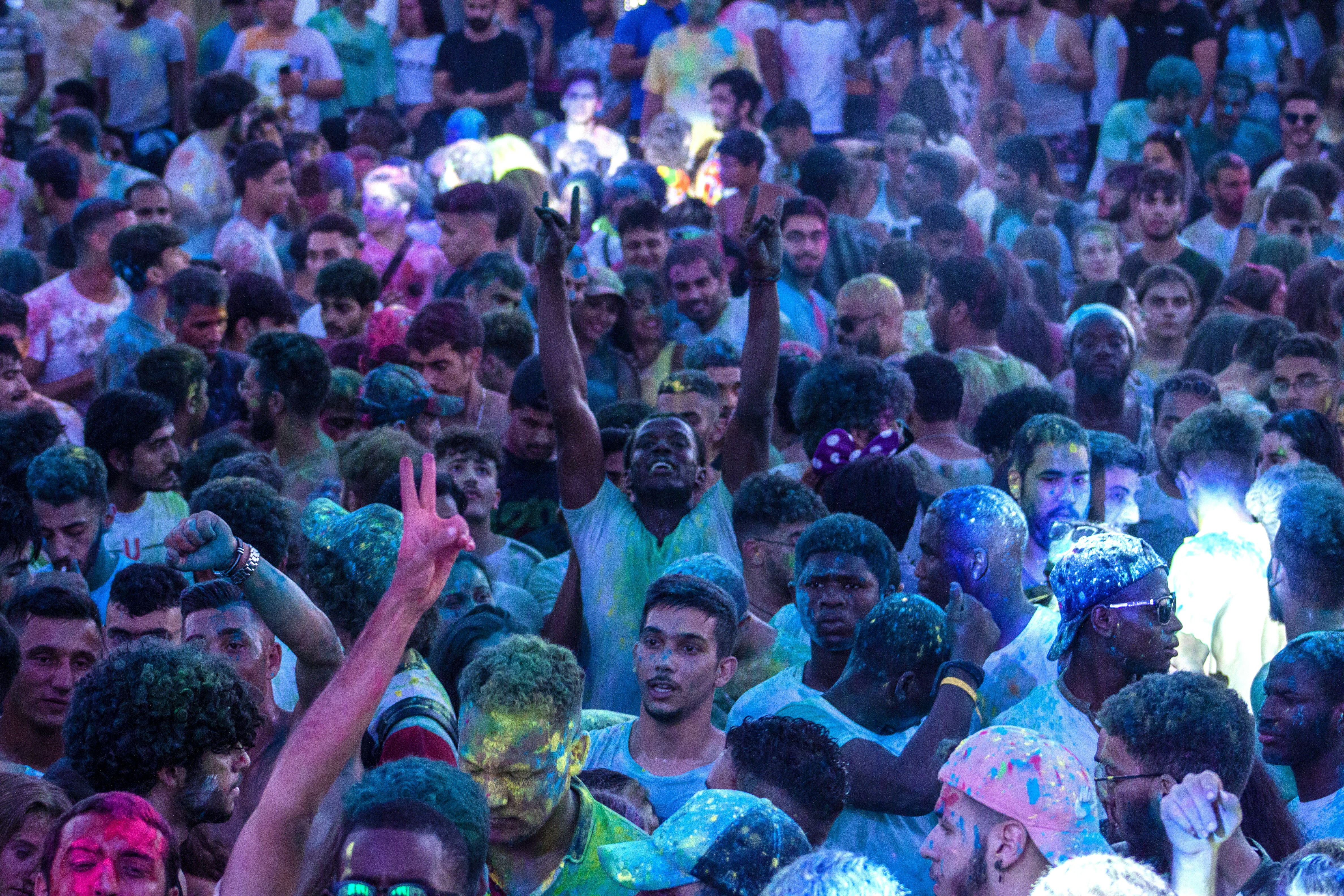 a group of people standing in front of a large crowd of people