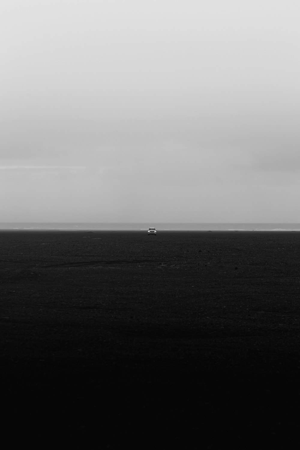 a black and white photo of a boat out in the ocean