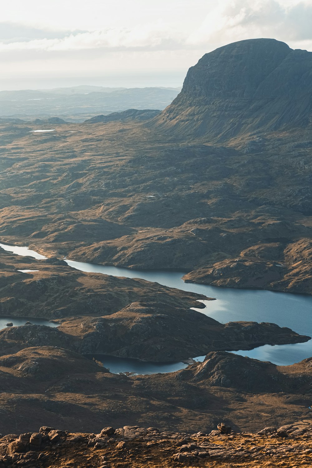 a view of a mountain range with a body of water in the foreground