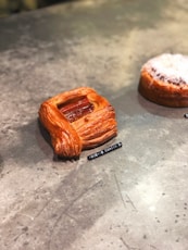 two pastries sitting on a table next to each other