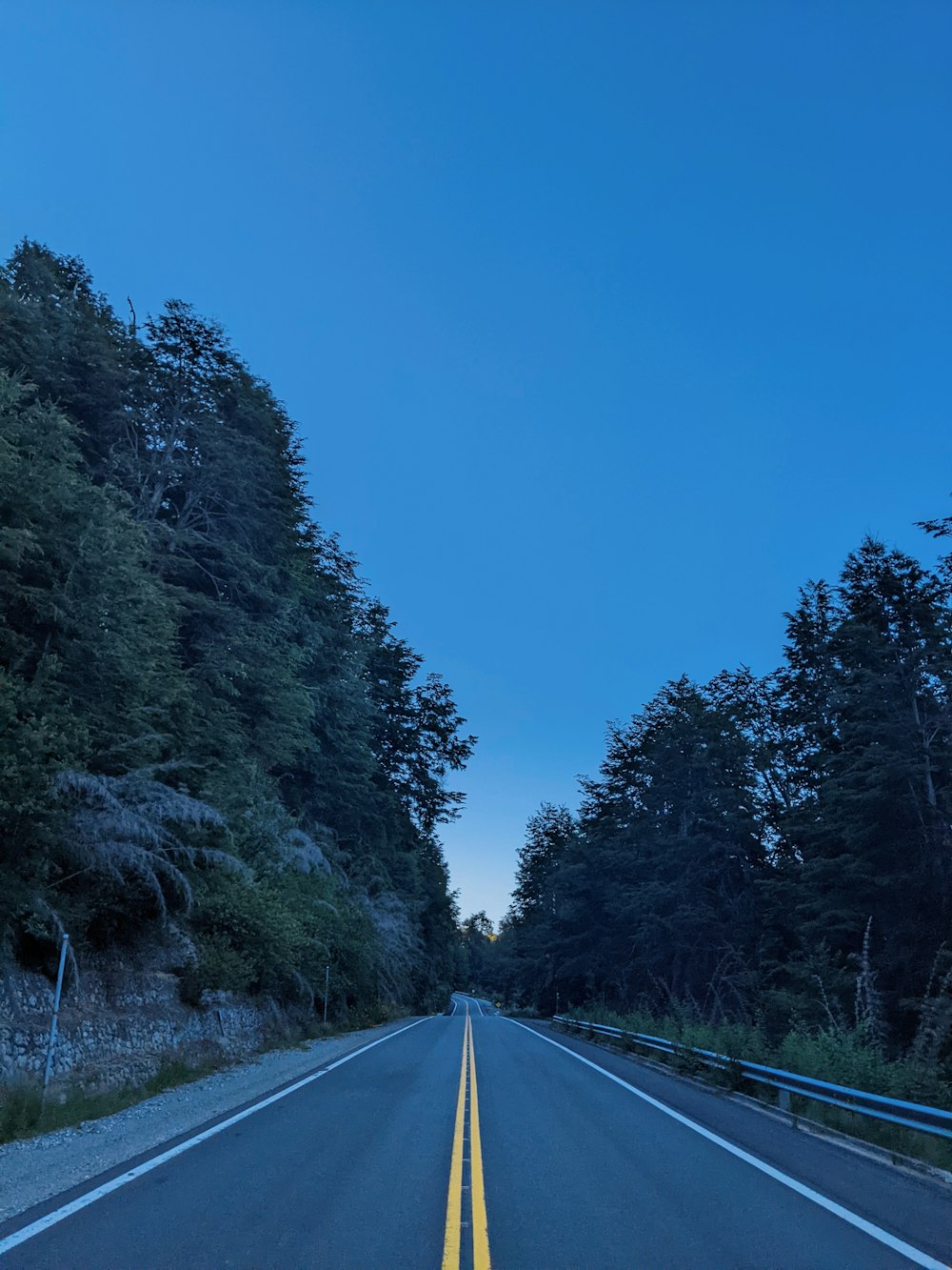 a road with a yellow line on the side of it