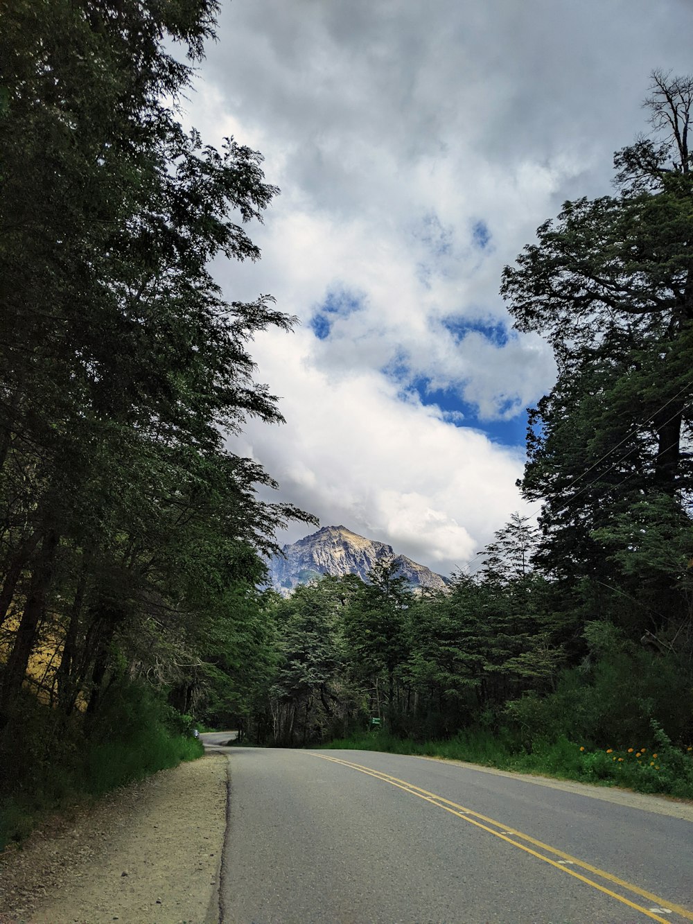 a road with a mountain in the background