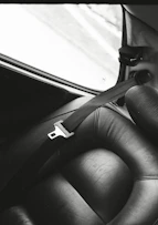 a black and white photo of a seat in a car