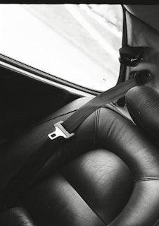 a black and white photo of a seat in a car