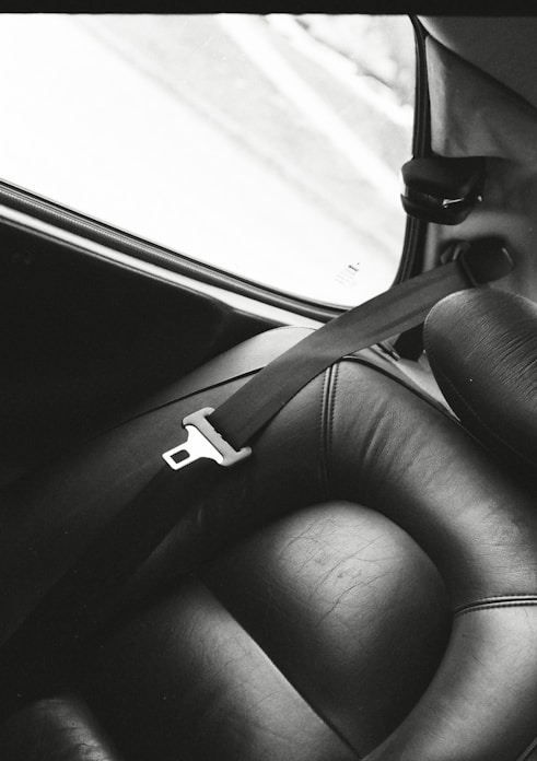 a black and white photo of a seat in a car