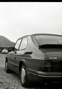a black and white photo of a saab 900 SPG car