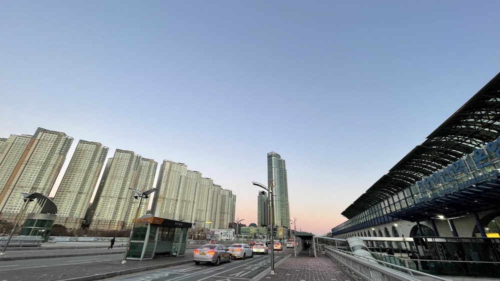 a train station with cars parked in front of it