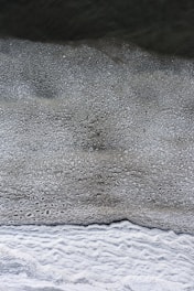 a black and white photo of water and sand
