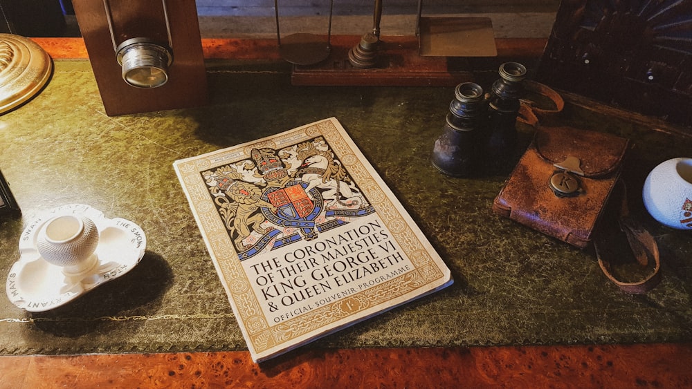 a book sitting on top of a table next to a cup and saucer