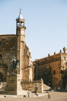a tall clock tower sitting next to a tall building