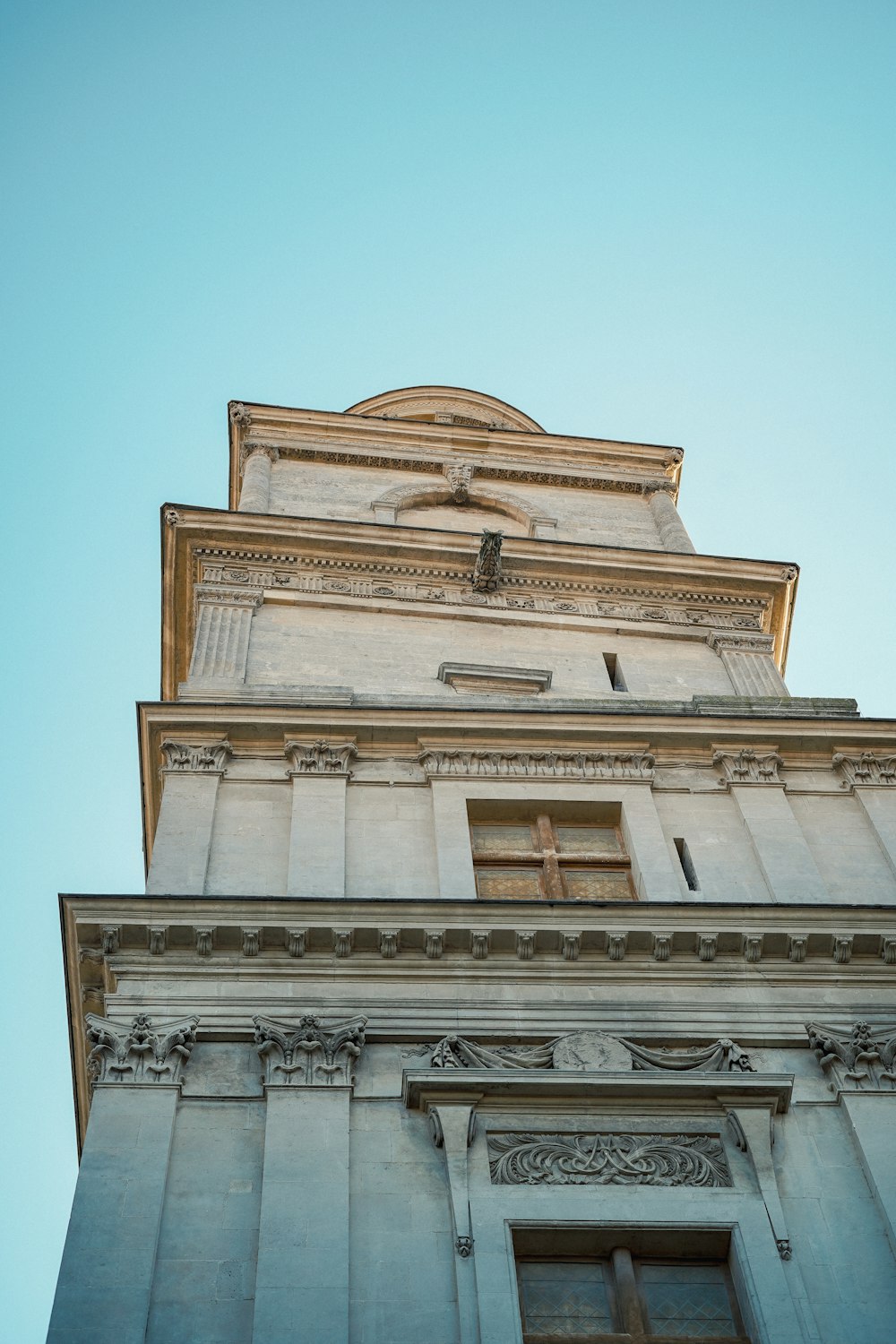 a tall building with a cross on the top of it