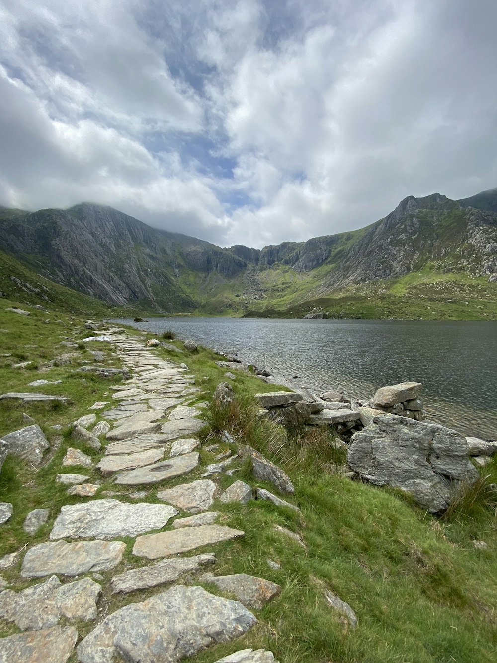 a stone path leading to a body of water