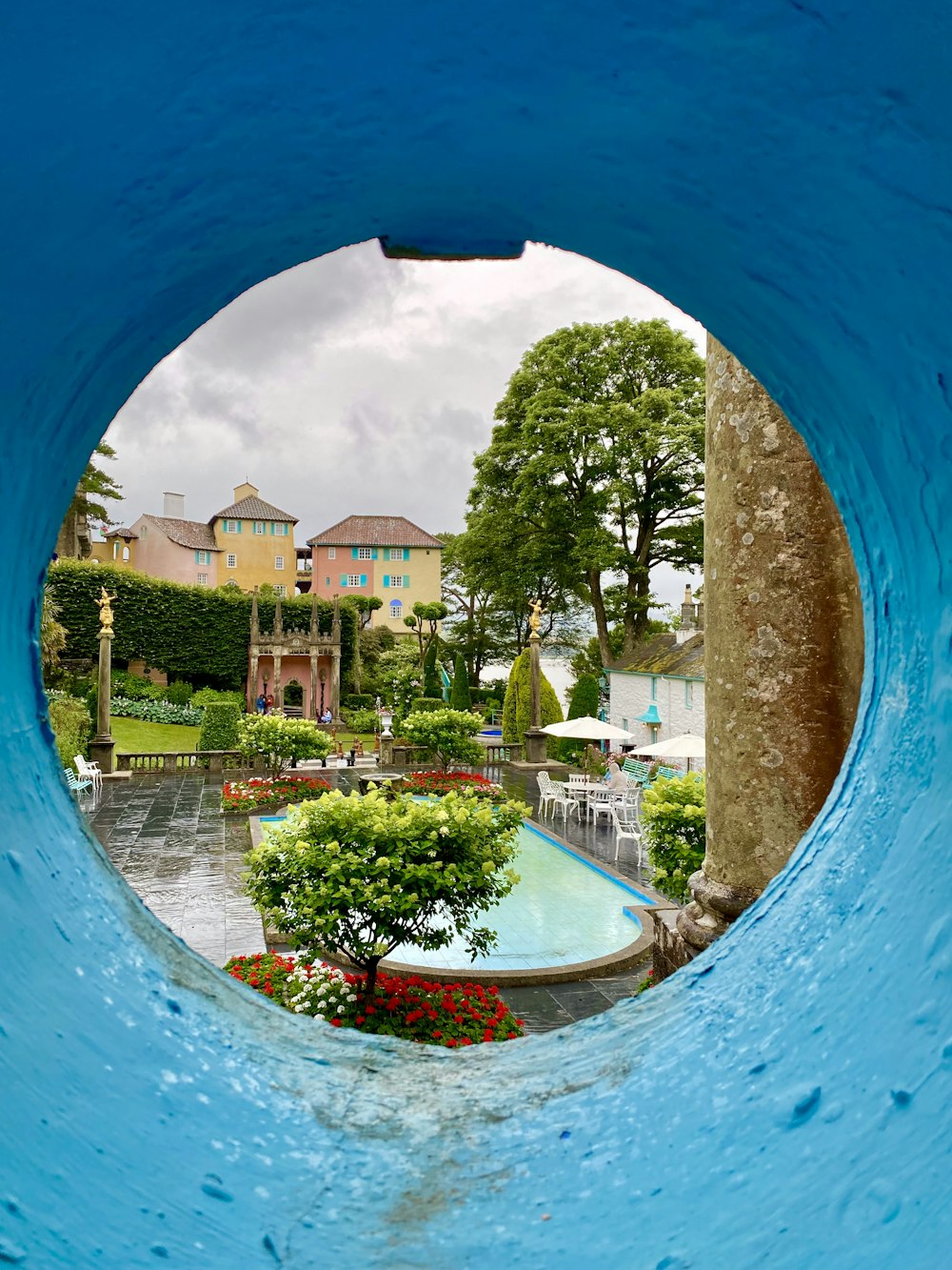 a view of a pool through a hole in a wall