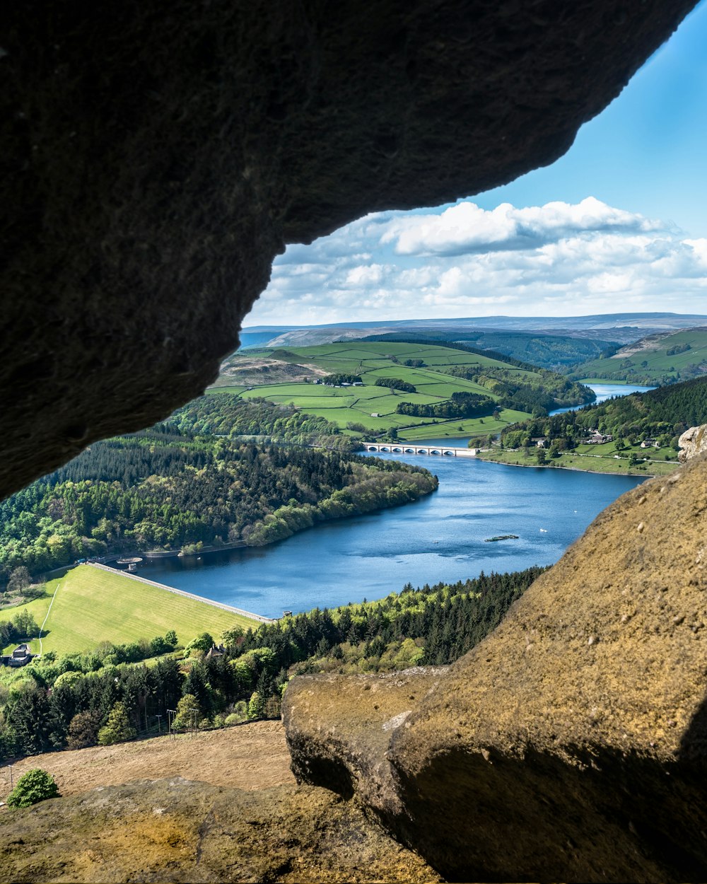 a view of a lake from a cave