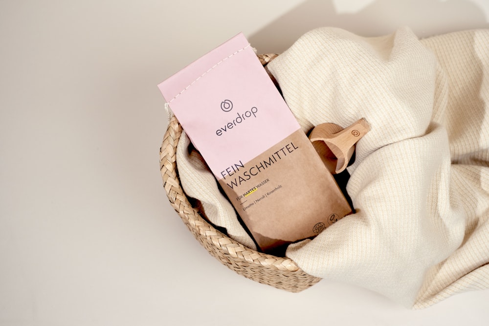 a basket with a towel and a packet of soap
