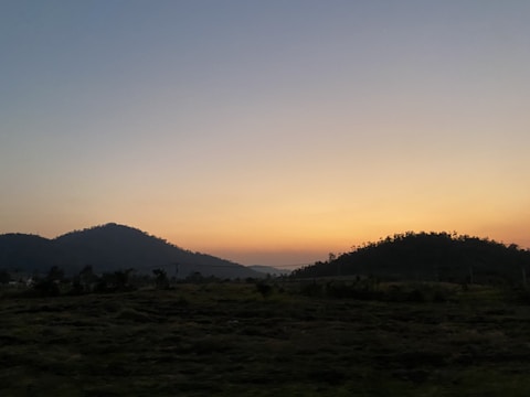 Elegant dark blue and gold themed image of Uruguayan pampas landscape at sunset.