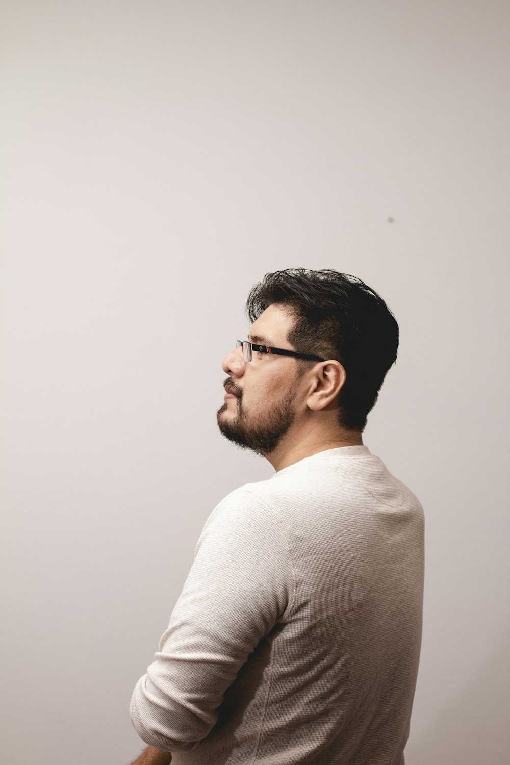 a man with glasses looking off into the distance