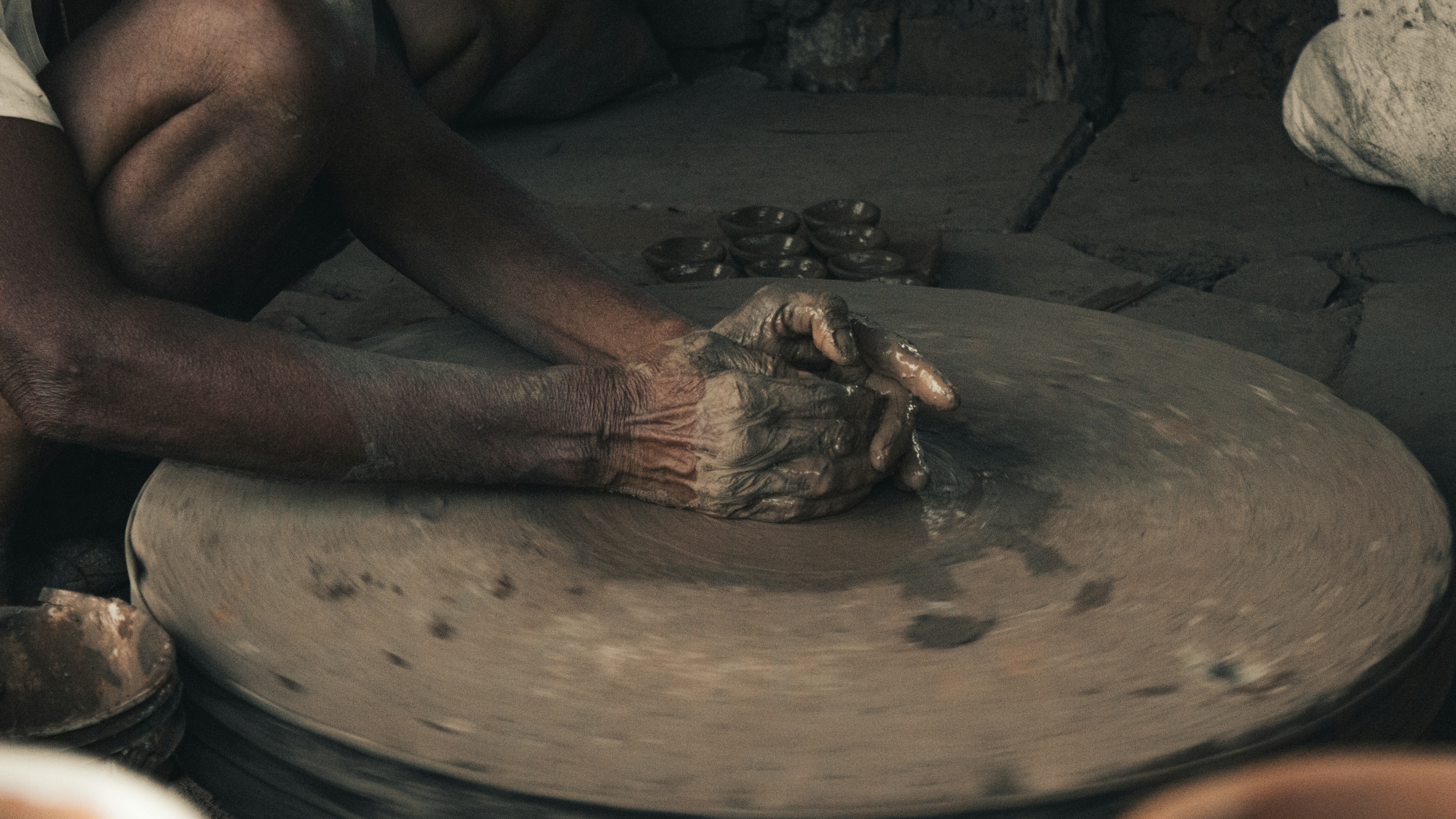 Old man making clay pottery.