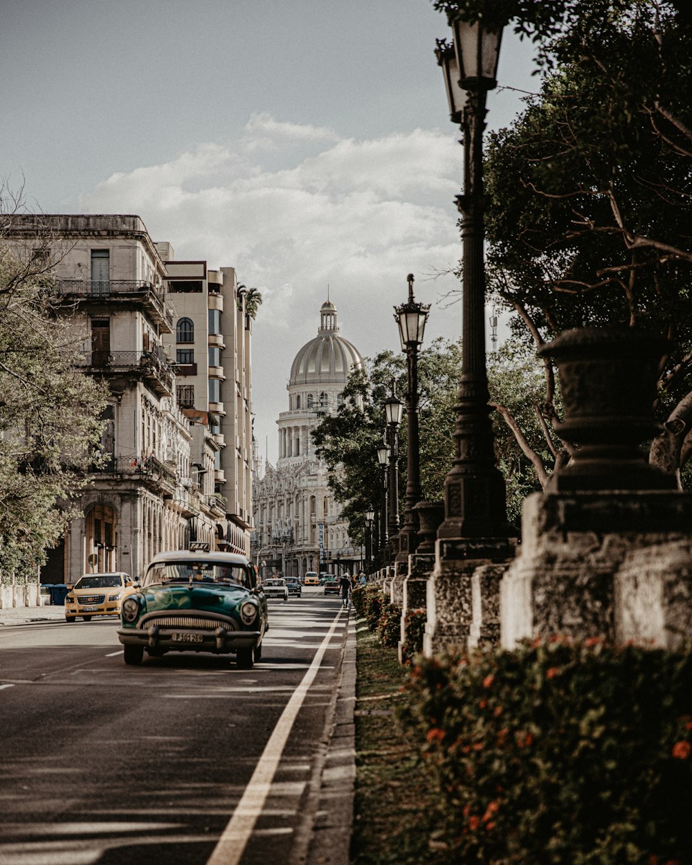 a car driving down a street next to tall buildings