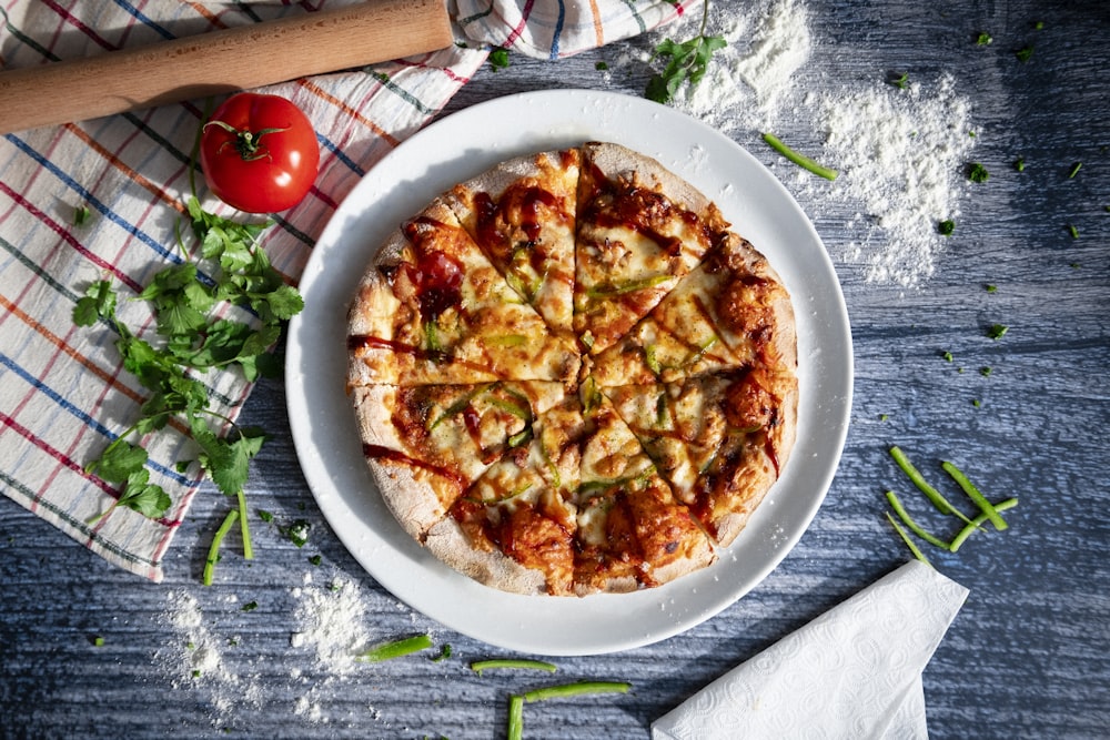 a pizza sitting on top of a white plate