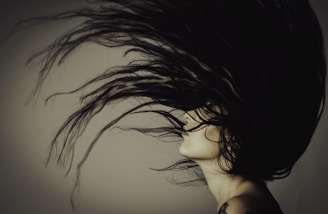 a woman with her hair blowing in the wind