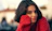 a close up of a person wearing a red sweater