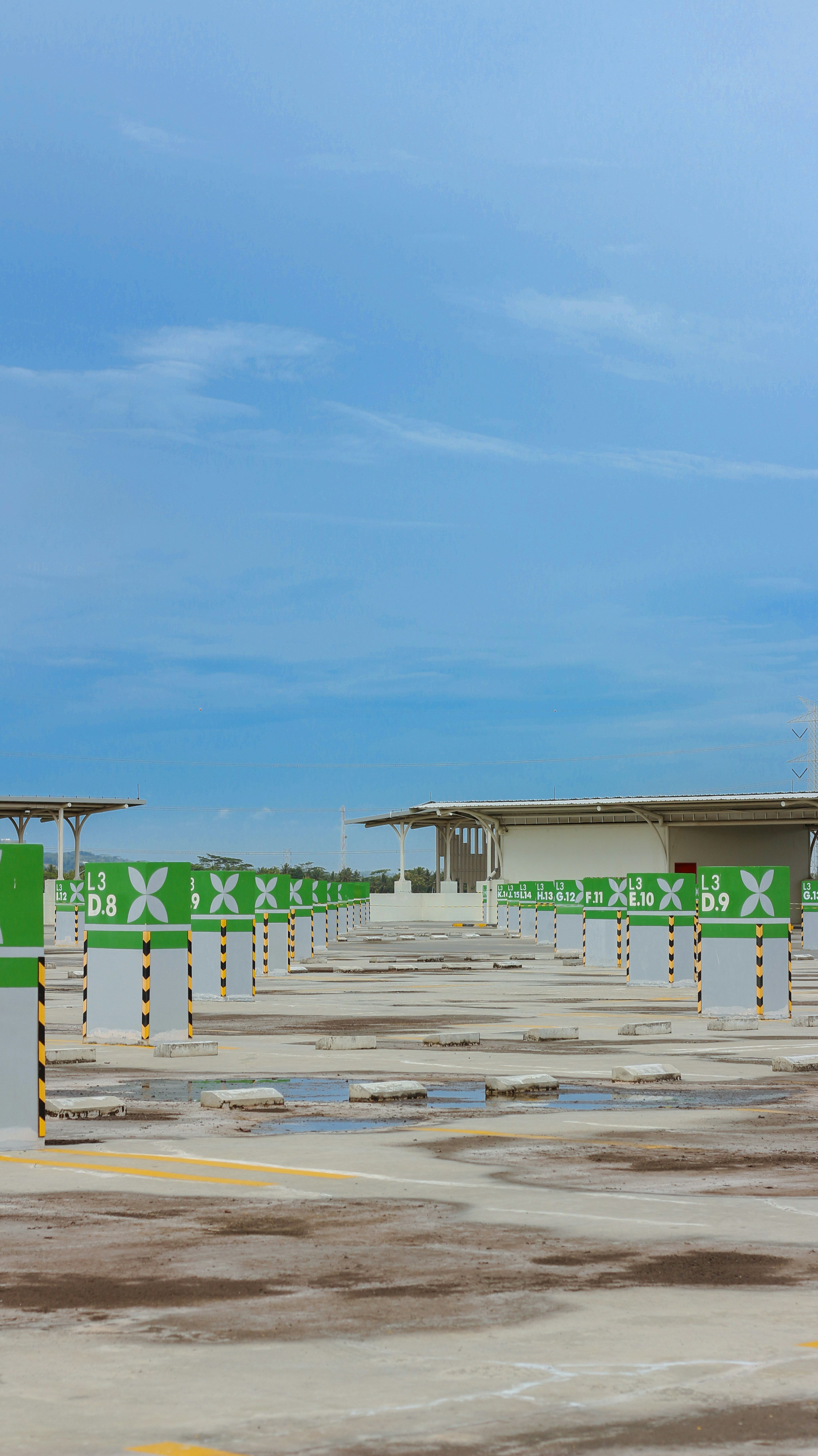 an empty parking lot with a green and white sign