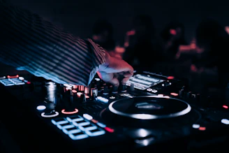 a dj mixing music in front of a crowd
