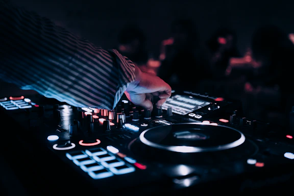 a dj mixing music in front of a crowd