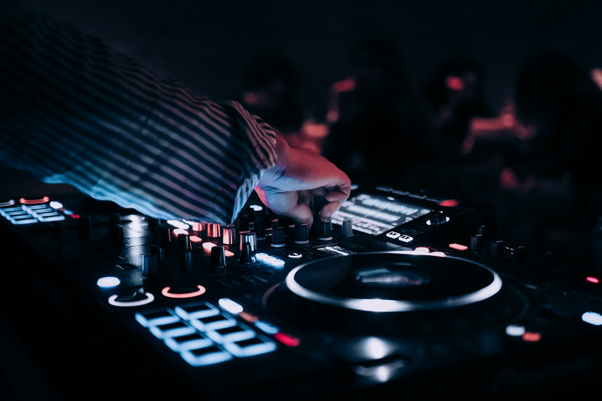 a dj mixing music in front of a crowd