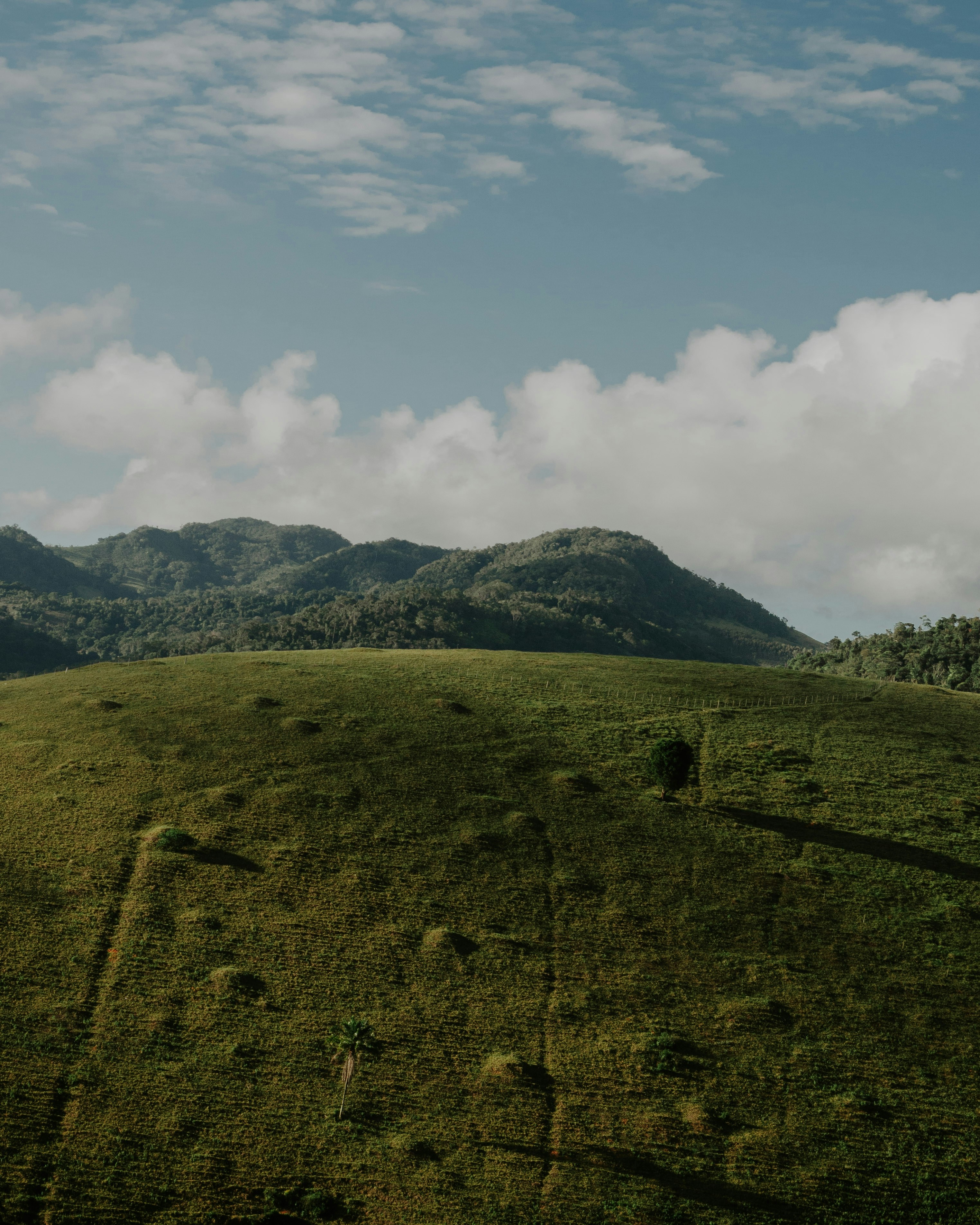 A mountain range with dramatic peaks under a blue sky.