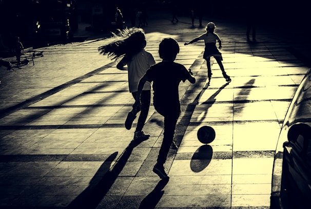 Children playing soccer during a sunny afternoon training session in Jacareí.