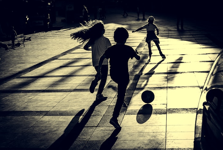 a group of young children playing a game of soccer