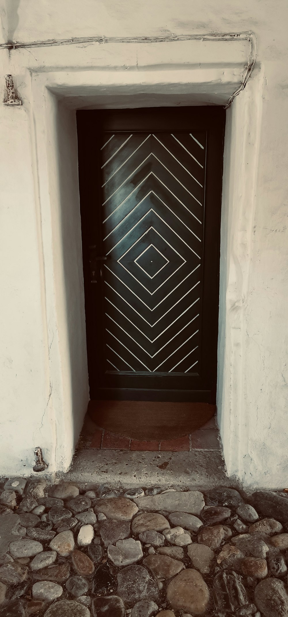 a black door with a diamond pattern on it