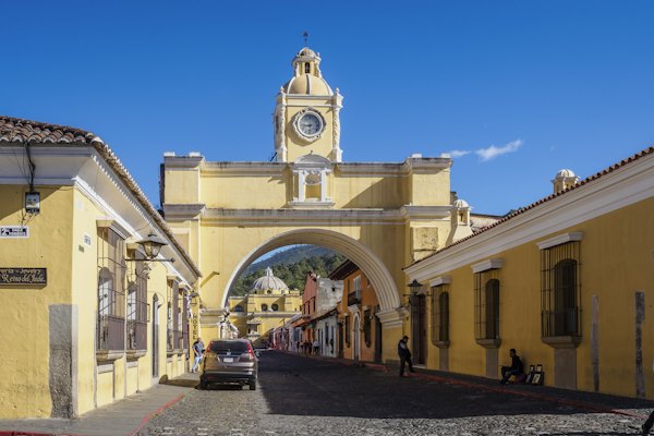 A yellow building with a clock tower on top of it — Antigua, Guatemala