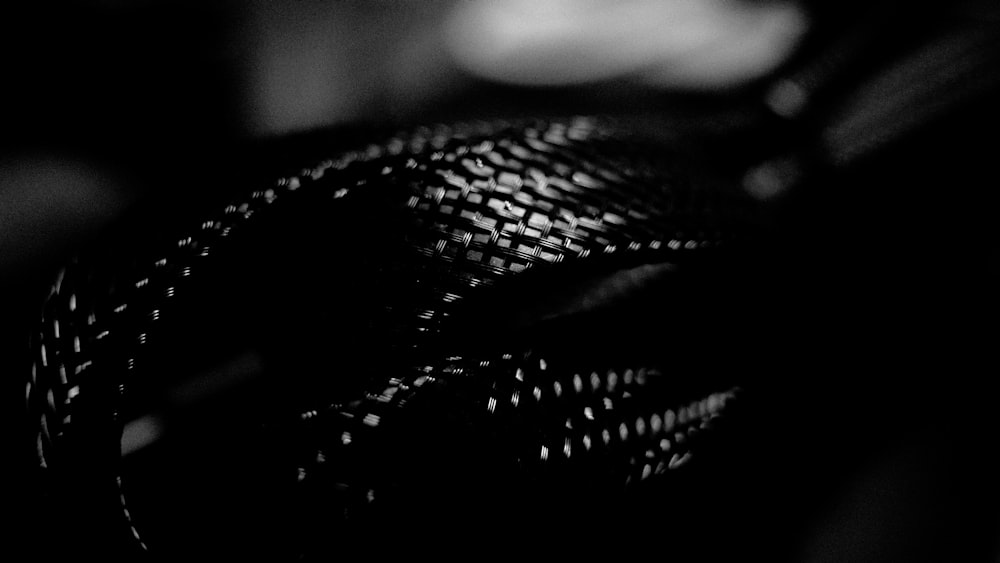 a black and white photo of a woven bag