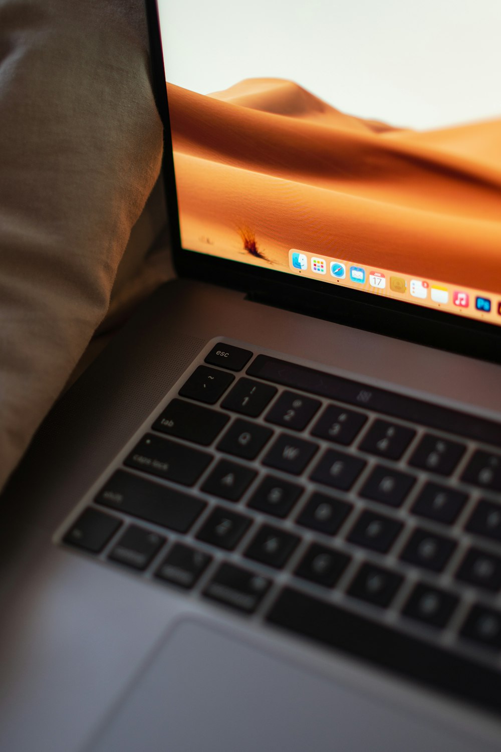 an open laptop computer sitting on top of a bed