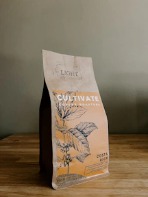 a bag of coffee sitting on top of a wooden table