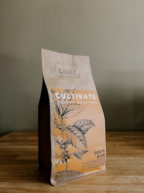 a bag of coffee sitting on top of a wooden table