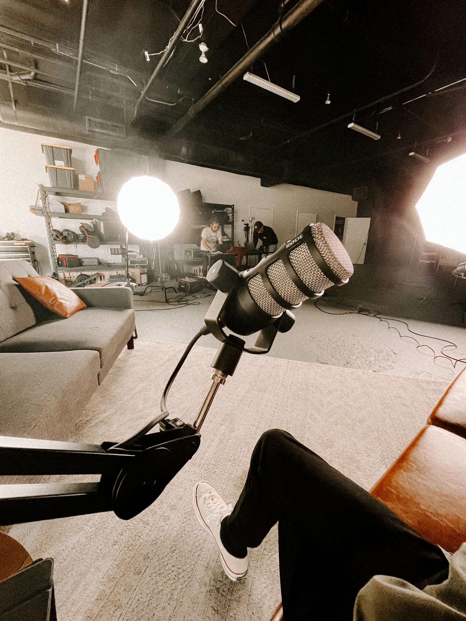 Cosy recording room with a couch and a microphone