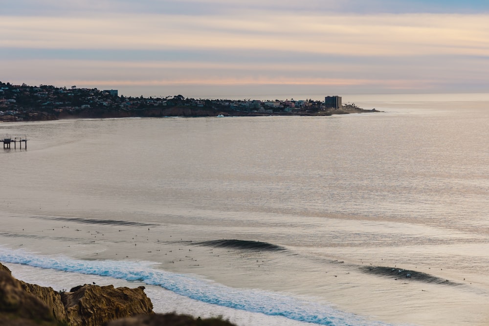 a body of water with a city in the background