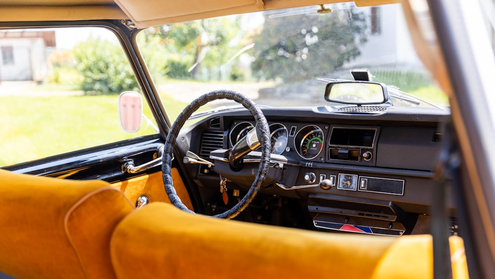 the interior of a car with a steering wheel and dashboard