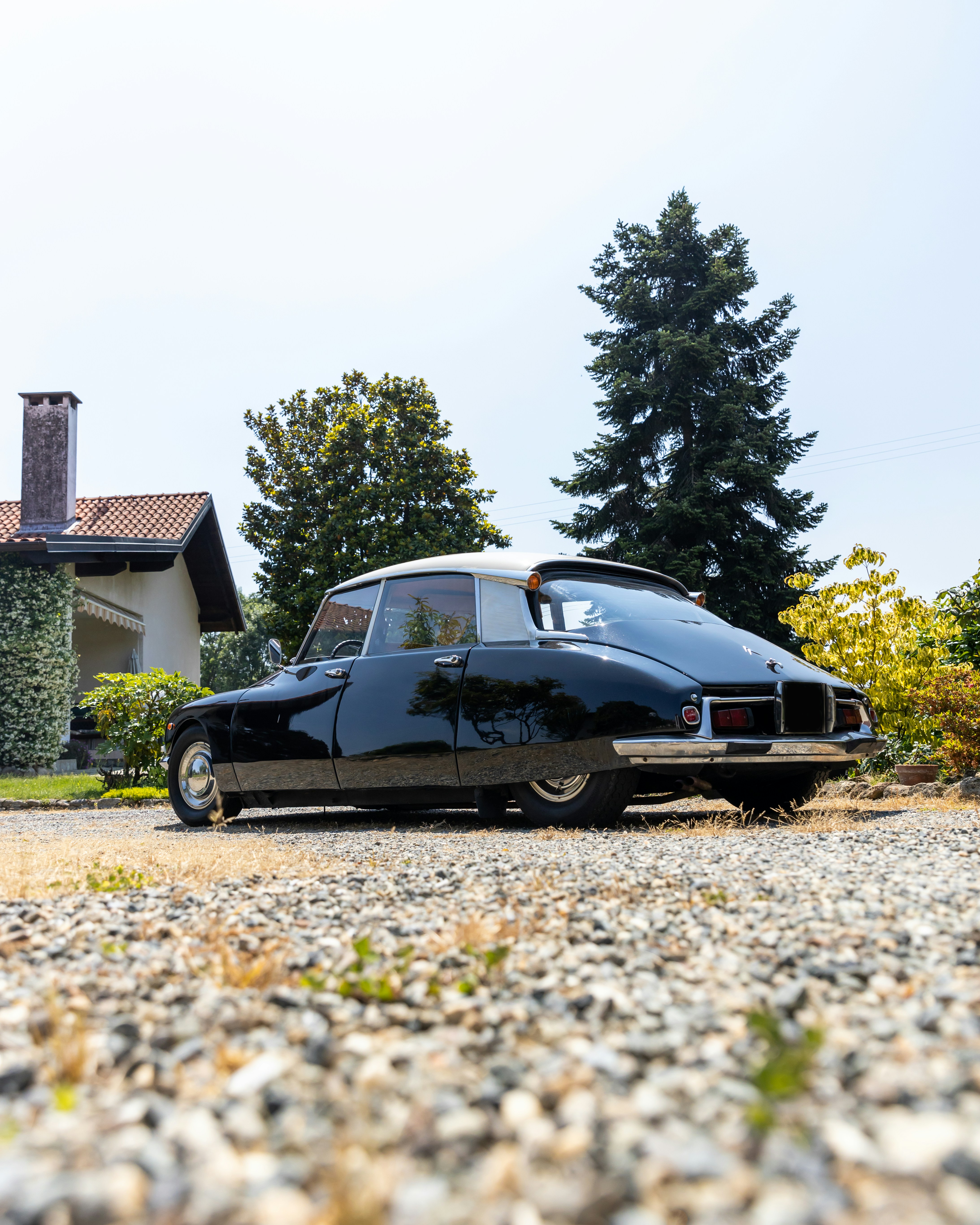 a black car parked in front of a house