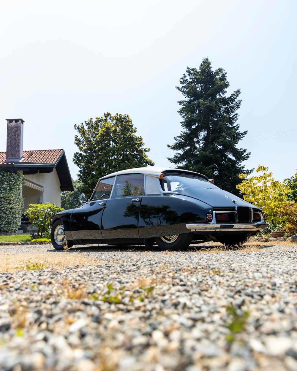 a black car parked in front of a house