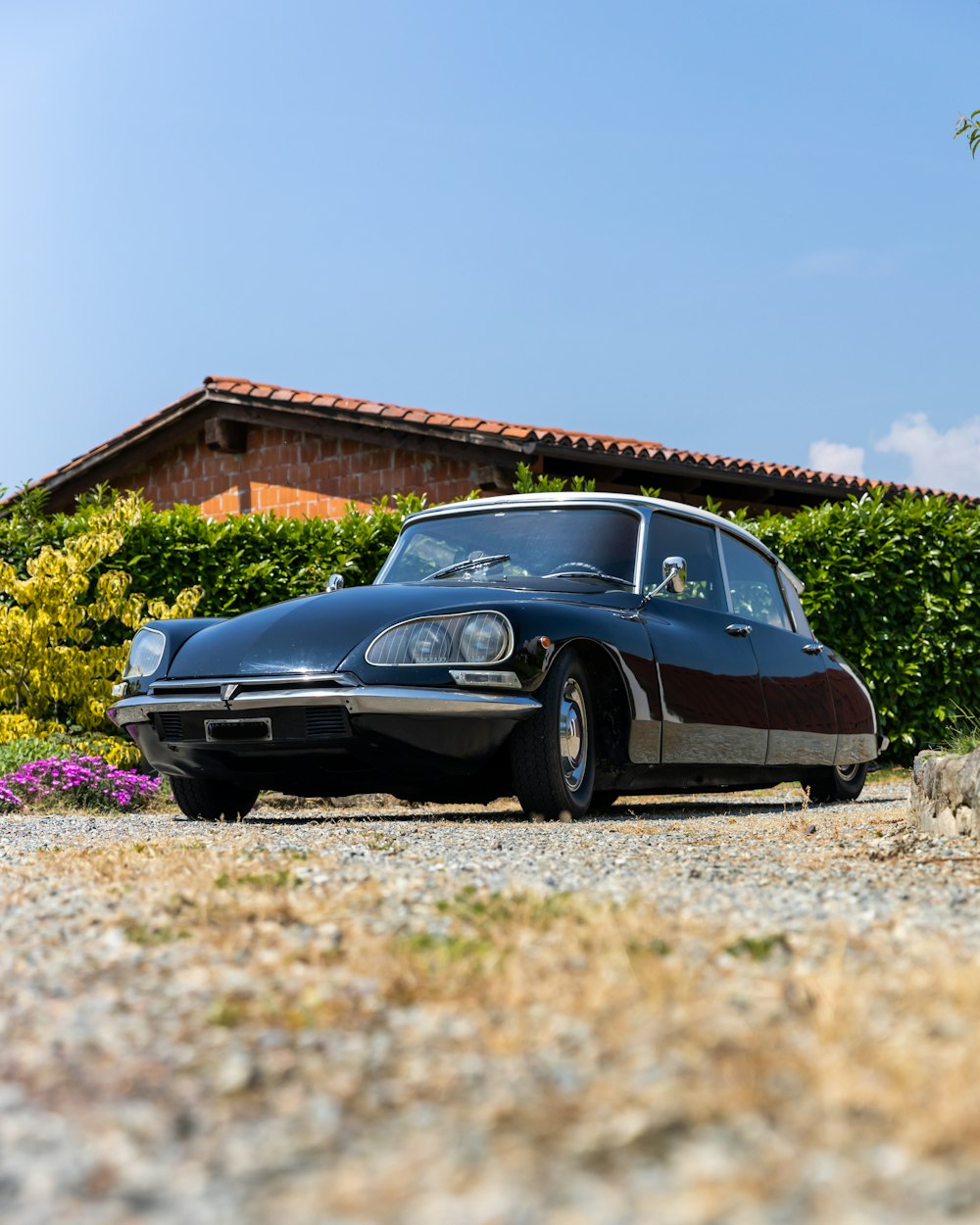 a black car parked in front of a house