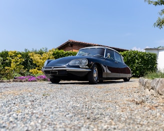 a black car parked in front of a house
