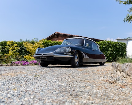 a black car parked in front of a house