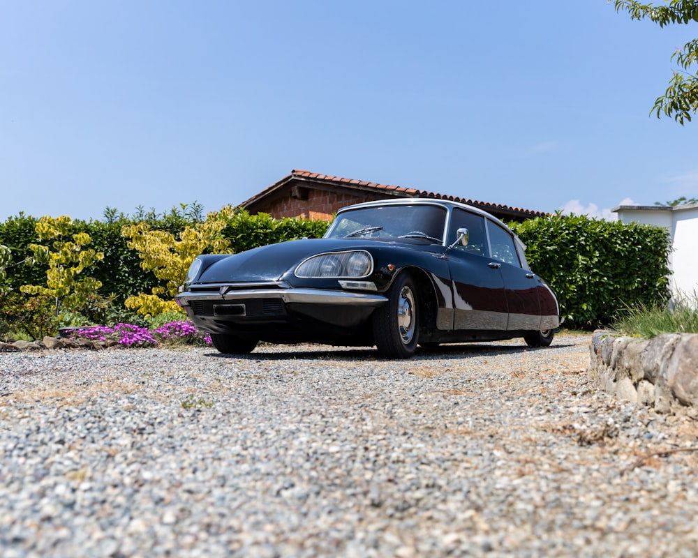 a black car parked in front of a house