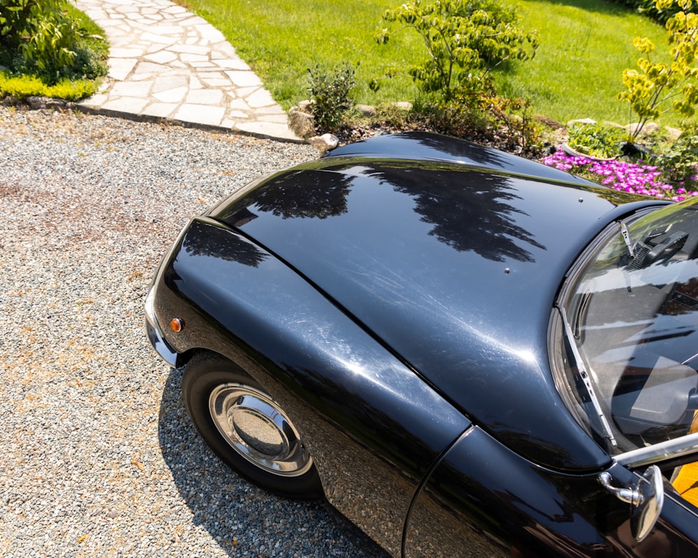 a black sports car parked in a driveway