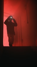 a man standing in front of a red light